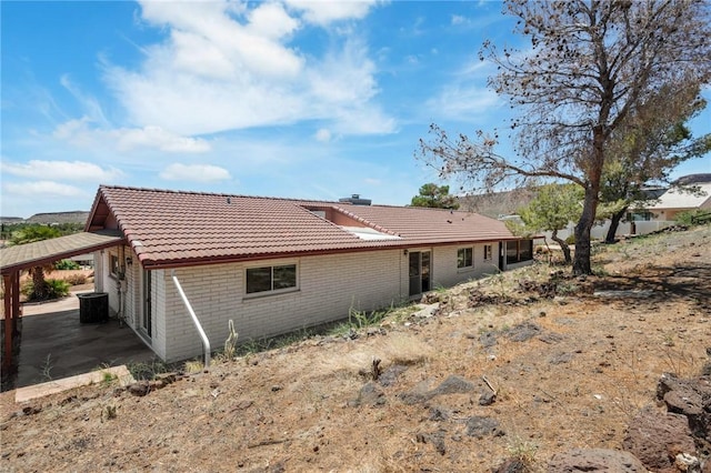 898 Crestwood Ln, Kingman, AZ 86409 - rear view of property featuring a tile roof, brick siding, and a carport