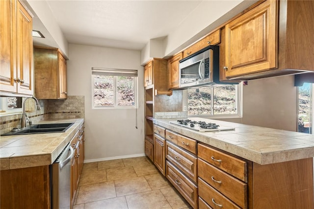 898 Crestwood Ln, Kingman, AZ 86409 - kitchen with appliances with stainless steel finishes, healthy amount of natural light, backsplash, and brown cabinetry