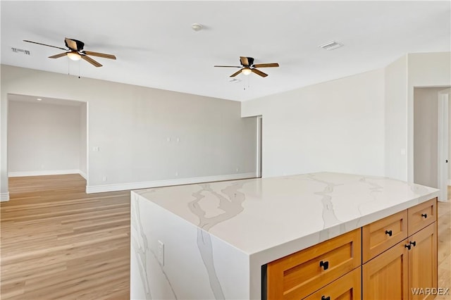 kitchen featuring light wood-style flooring, visible vents, and a ceiling fan