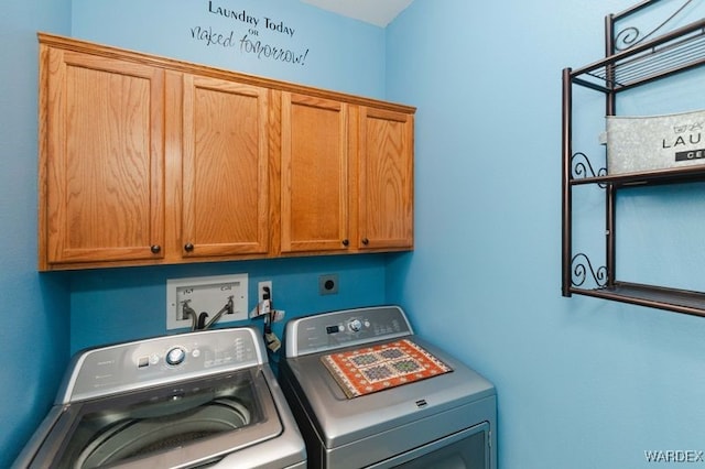 washroom featuring cabinet space and independent washer and dryer