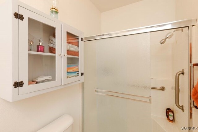 bathroom with a shower with shower door