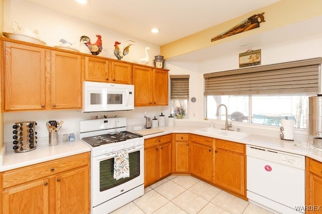 kitchen featuring light tile patterned floors, white appliances, a sink, light countertops, and brown cabinets