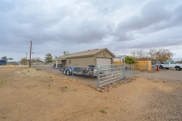 exterior space featuring fence and a garage