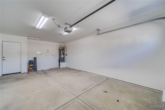 garage with a garage door opener and electric water heater