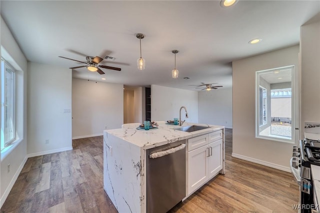 kitchen with a sink, light wood finished floors, white cabinetry, and stainless steel appliances