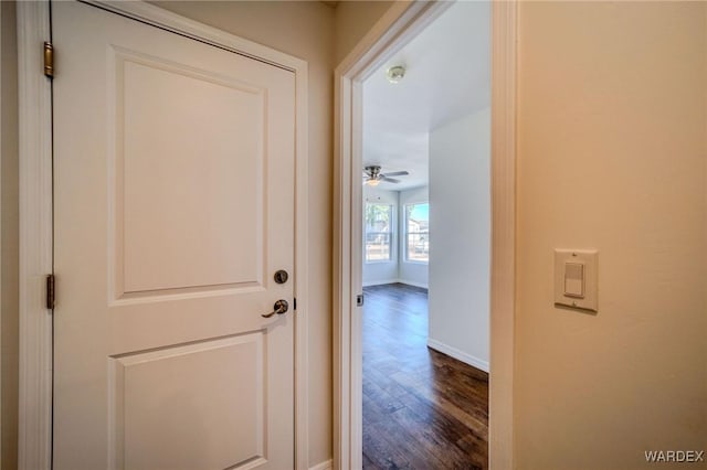 hall featuring dark wood finished floors and baseboards