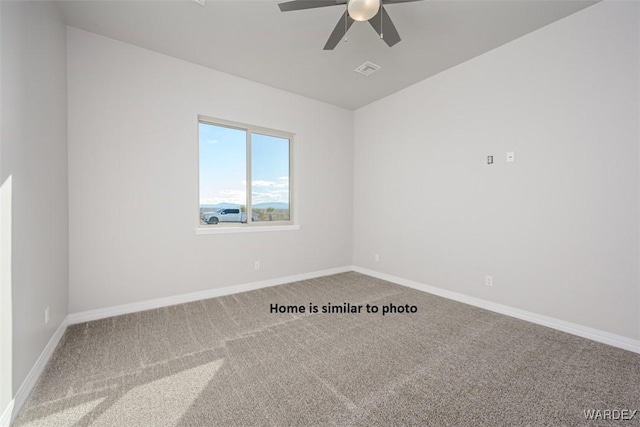 empty room with carpet floors, visible vents, baseboards, and ceiling fan