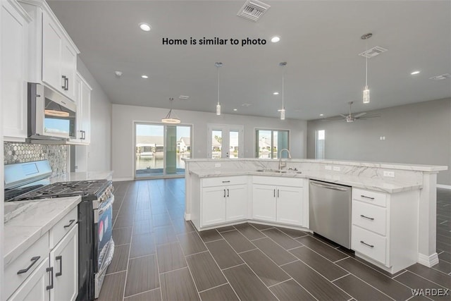 kitchen featuring visible vents, stainless steel appliances, a sink, and white cabinetry