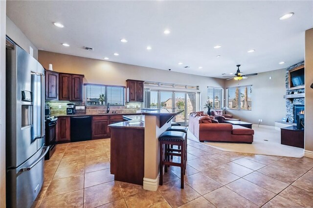10726 S Shimmering Way, Mohave Valley, AZ 86440 - kitchen with high end refrigerator, a breakfast bar area, light tile patterned flooring, open floor plan, and recessed lighting