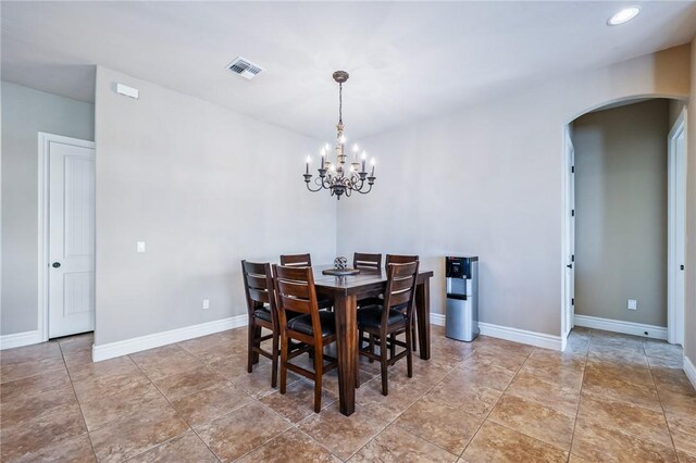 10726 S Shimmering Way, Mohave Valley, AZ 86440 - dining area featuring arched walkways and a chandelier