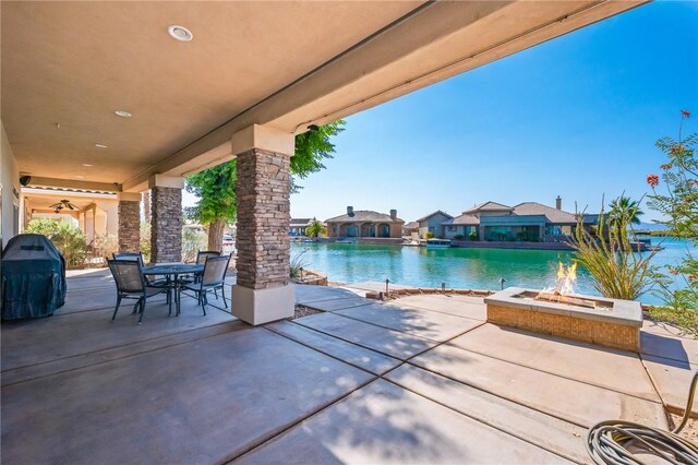 10726 S Shimmering Way, Mohave Valley, AZ 86440 - view of swimming pool with a fire pit, a patio, outdoor dining area, grilling area, and a water view