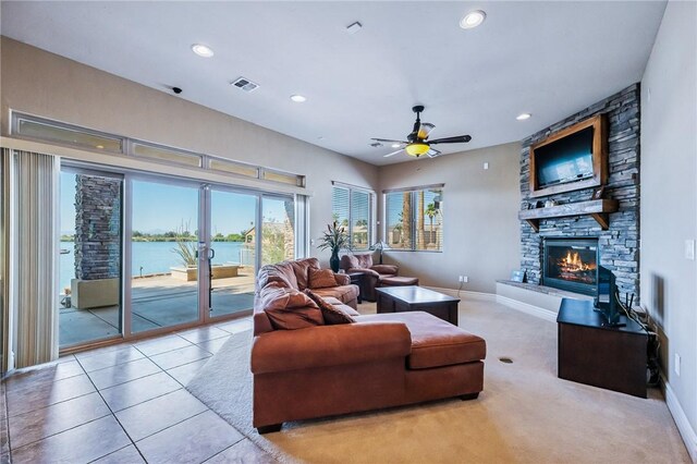 10726 S Shimmering Way, Mohave Valley, AZ 86440 - living area featuring a fireplace, ceiling fan, recessed lighting, a water view, and tile patterned flooring