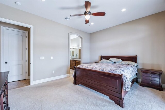 10726 S Shimmering Way, Mohave Valley, AZ 86440 - bedroom featuring carpet flooring, arched walkways, recessed lighting, connected bathroom, and a ceiling fan