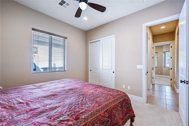 10726 S Shimmering Way, Mohave Valley, AZ 86440 - bedroom featuring light carpet, light tile patterned floors, a closet, ceiling fan, and recessed lighting
