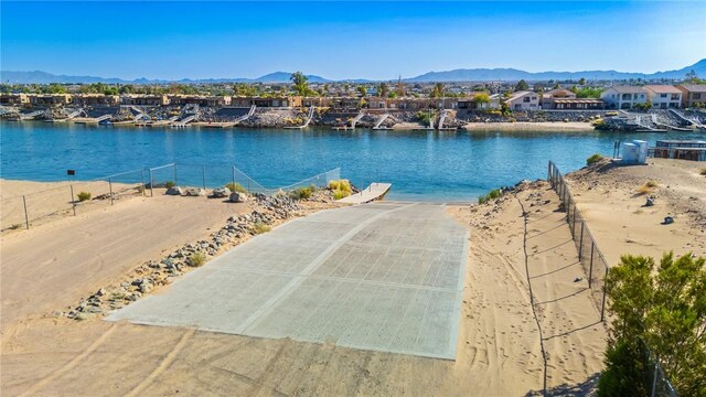 10726 S Shimmering Way, Mohave Valley, AZ 86440 - water view with a boat ramp, nearby suburban area, and a mountain backdrop