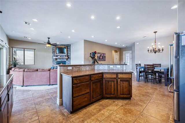 10726 S Shimmering Way, Mohave Valley, AZ 86440 - kitchen with ceiling fan, a chandelier, a fireplace, recessed lighting, and light tile patterned floors
