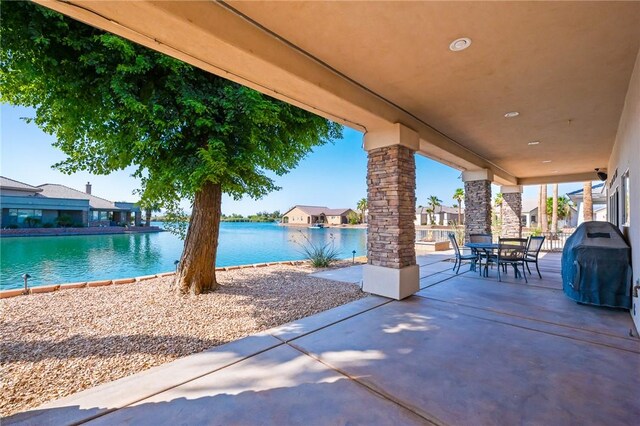 10726 S Shimmering Way, Mohave Valley, AZ 86440 - view of patio with outdoor dining space, a water view, and a grill