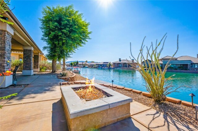 10726 S Shimmering Way, Mohave Valley, AZ 86440 - view of swimming pool featuring a fire pit, a patio, a water view, and a residential view