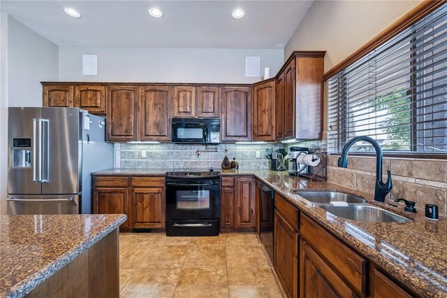10726 S Shimmering Way, Mohave Valley, AZ 86440 - kitchen featuring black appliances, dark stone counters, backsplash, light tile patterned flooring, and recessed lighting