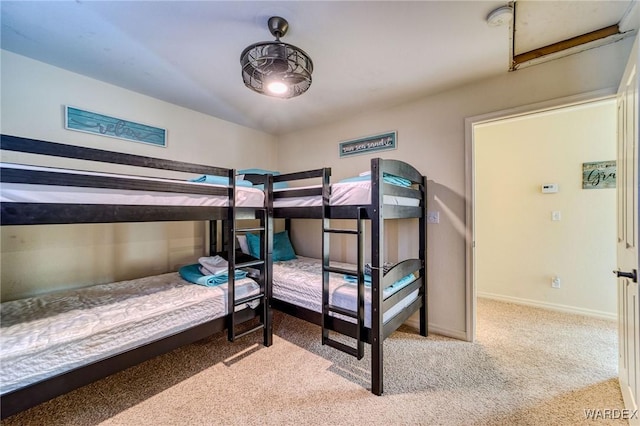 bedroom featuring light carpet and baseboards