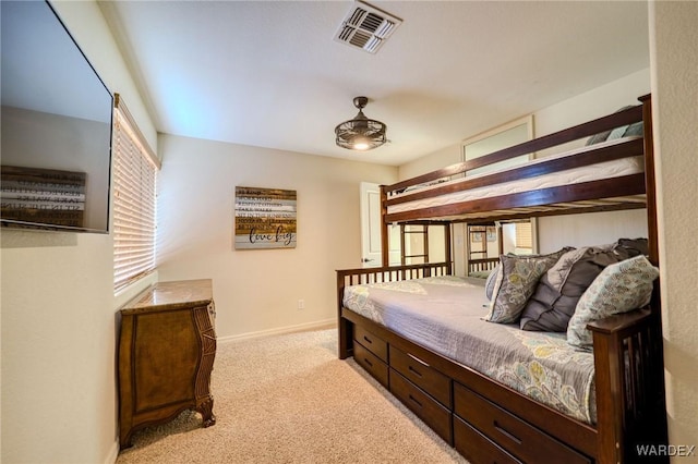 bedroom with baseboards, visible vents, and light colored carpet