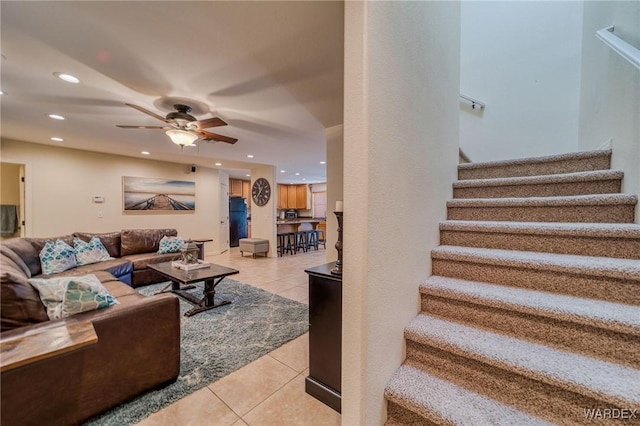 living area featuring light tile patterned floors, stairway, and recessed lighting