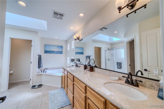 full bath with a garden tub, a skylight, a sink, visible vents, and a shower stall