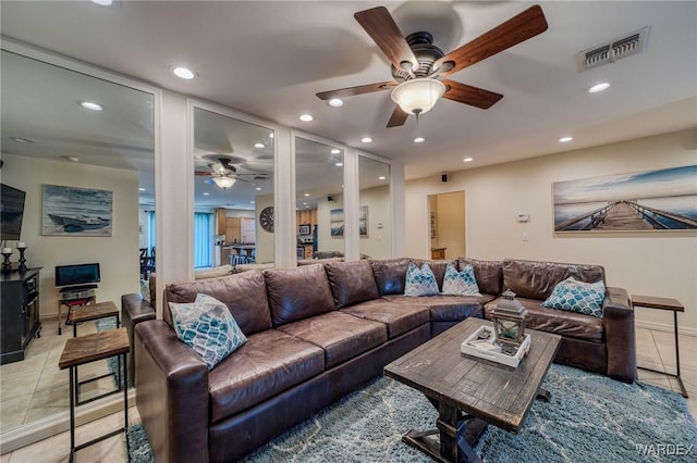 living room with light tile patterned floors, a ceiling fan, visible vents, and recessed lighting