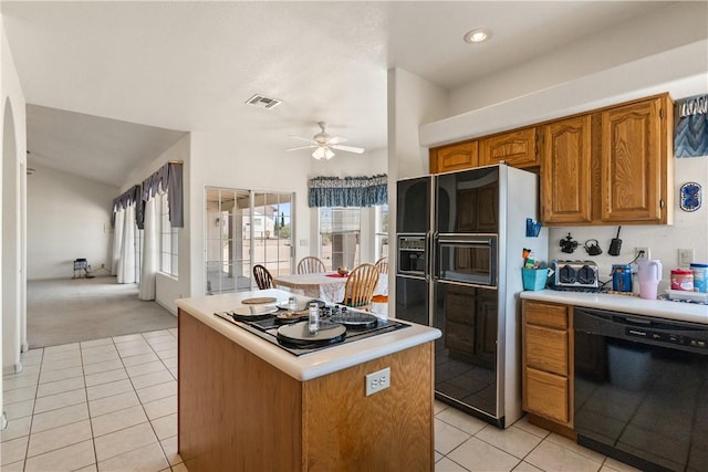3628 N Venus Ct, Golden Valley, AZ 86413 - kitchen with black appliances, light tile patterned floors, and light countertops