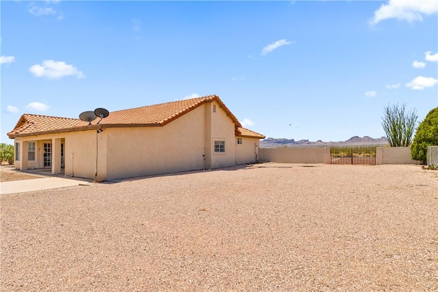3628 N Venus Ct, Golden Valley, AZ 86413 - back of house featuring stucco siding, a tile roof, and a mountain view