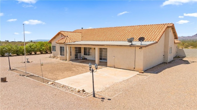 3628 N Venus Ct, Golden Valley, AZ 86413 - rear view of house with stucco siding, a tiled roof, a patio, and a mountain view