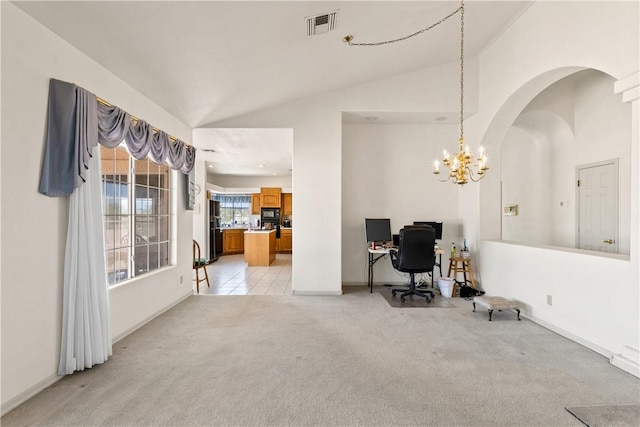 3628 N Venus Ct, Golden Valley, AZ 86413 - living area with vaulted ceiling, arched walkways, light colored carpet, an office area, and a chandelier