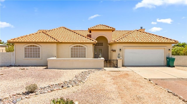 3628 N Venus Ct, Golden Valley, AZ 86413 - mediterranean / spanish house with stucco siding, an attached garage, concrete driveway, a tiled roof, and a chimney