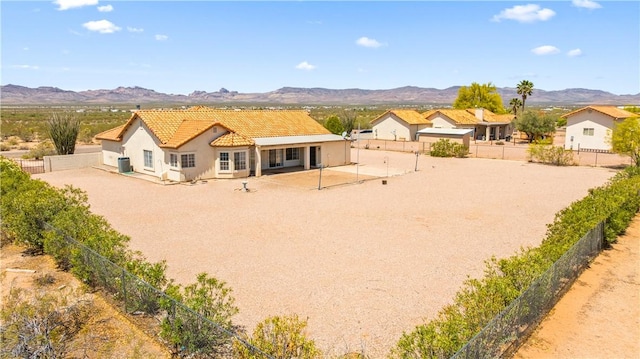 3628 N Venus Ct, Golden Valley, AZ 86413 - back of property featuring a mountain view, a tile roof, stucco siding, and a fenced backyard