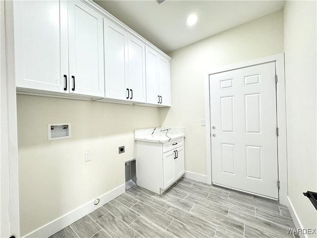 laundry area with cabinet space, baseboards, washer hookup, and electric dryer hookup