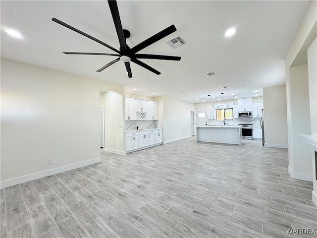 unfurnished living room featuring recessed lighting, visible vents, and light wood-style flooring