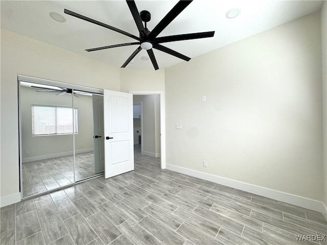 unfurnished bedroom with wood tiled floor and baseboards