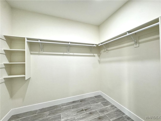 walk in closet featuring wood finish floors