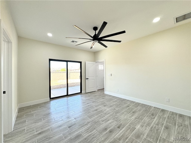 unfurnished room featuring ceiling fan, light wood-type flooring, visible vents, and baseboards