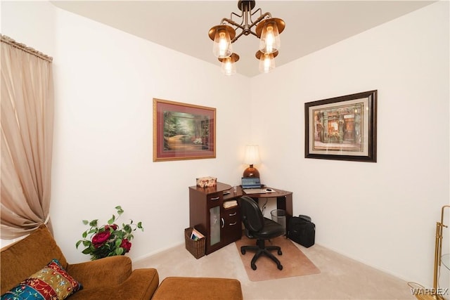 home office with light carpet and an inviting chandelier