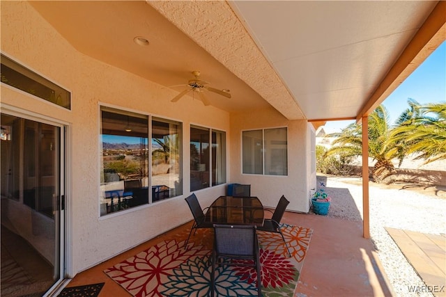 view of patio with outdoor dining space and a ceiling fan