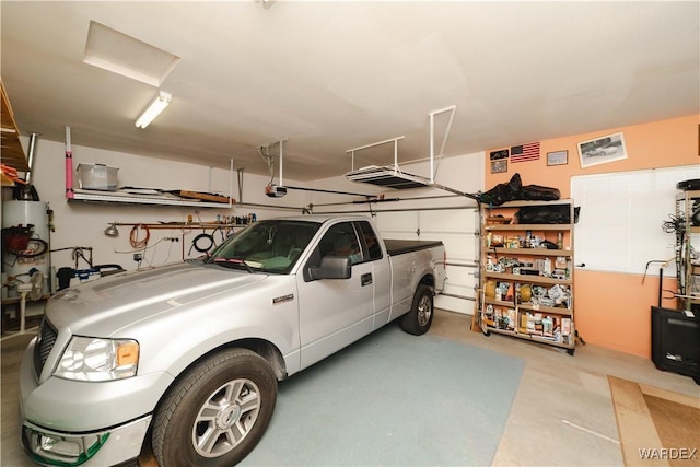 garage featuring water heater and a garage door opener