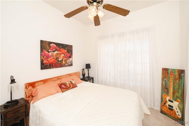 bedroom with ceiling fan and light colored carpet