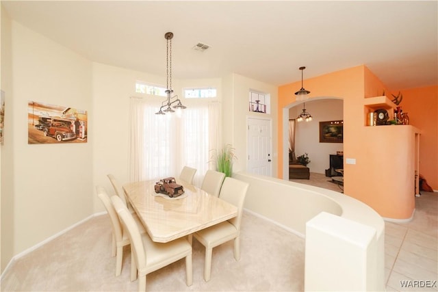 dining space with an inviting chandelier, baseboards, and visible vents