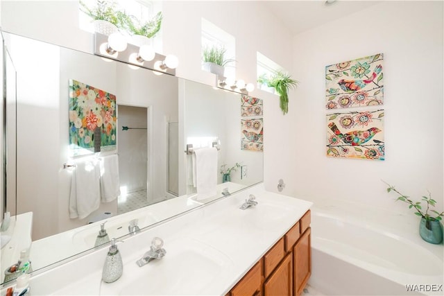 bathroom featuring a sink, double vanity, and a bath