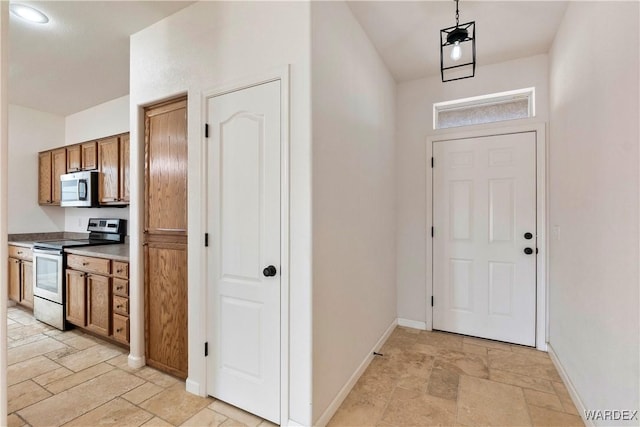 entryway featuring baseboards and stone tile floors