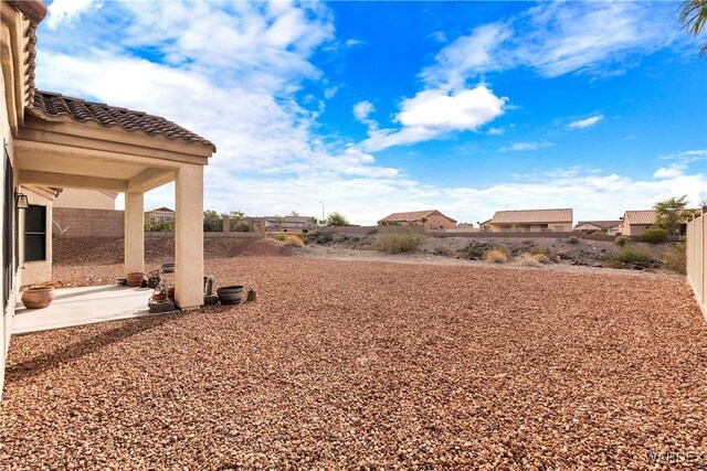 view of yard featuring a patio and fence