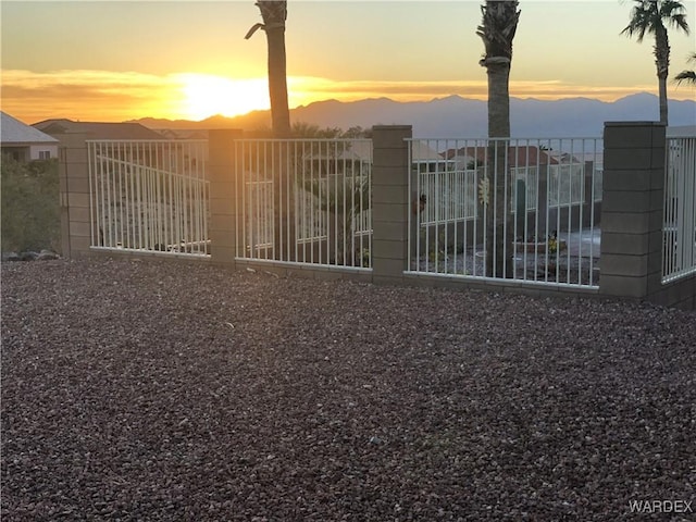 view of gate featuring a mountain view and fence