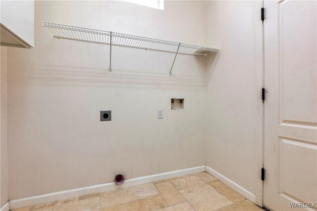 laundry area featuring hookup for a washing machine, stone finish flooring, hookup for an electric dryer, laundry area, and baseboards