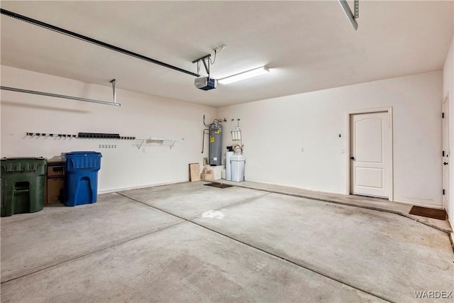 garage featuring water heater and a garage door opener